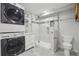 Modern bathroom featuring stackable washer/dryer, glass shower, and vanity at 4321 W 118Th Pl, Westminster, CO 80031