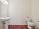 Bathroom with pedestal sink and cherry-stained floors at 4321 W 118Th Pl, Westminster, CO 80031