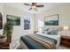 Bright bedroom with a ceiling fan, large window, and comfortable bed with decorative pillows and artwork at 4321 W 118Th Pl, Westminster, CO 80031