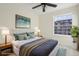 Bedroom featuring a large window, ceiling fan, comfortable bed, and stylish decor in a staged setting at 4321 W 118Th Pl, Westminster, CO 80031