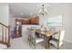 Virtually staged dining room with a wooden table and kitchen views at 4321 W 118Th Pl, Westminster, CO 80031