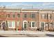 Brick townhome with a charming front porch and landscaping at 4321 W 118Th Pl, Westminster, CO 80031