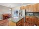 Well-lit kitchen with stainless steel appliances, a central island, and access to an outdoor patio and dining area at 4321 W 118Th Pl, Westminster, CO 80031