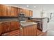 Kitchen with wood cabinets, stainless steel appliances, mosaic backsplash, and a convenient kitchen island at 4321 W 118Th Pl, Westminster, CO 80031