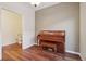 Cozy living room featuring hardwood floors and a classic upright piano at 4321 W 118Th Pl, Westminster, CO 80031