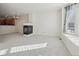 Spacious living room with a modern fireplace, large windows, and neutral carpet and paint at 4321 W 118Th Pl, Westminster, CO 80031