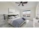 Virtually staged main bedroom with a striped comforter and ceiling fan at 4321 W 118Th Pl, Westminster, CO 80031