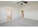 Main bedroom with ceiling fan, carpet, and access to laundry and bathroom at 4321 W 118Th Pl, Westminster, CO 80031