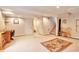 Large basement room featuring neutral tones, access to stairs, and an adjacent toilet at 6126 S Pierson St, Littleton, CO 80127