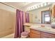 Cozy bathroom featuring a shower-tub combo, vanity with sink, and mirrored medicine cabinet at 6126 S Pierson St, Littleton, CO 80127