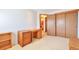 Bedroom with carpet, a closet, a desk and an open doorway to an ensuite bathroom at 6126 S Pierson St, Littleton, CO 80127