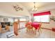 Open dining area with a table set for four, connecting to a cozy living room with fireplace at 6126 S Pierson St, Littleton, CO 80127