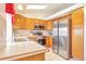 Modern kitchen with stainless steel appliances, light wood cabinets, and a bright atmosphere at 6126 S Pierson St, Littleton, CO 80127