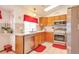 Bright kitchen with stainless steel appliances, light wood cabinets, and tile countertops at 6126 S Pierson St, Littleton, CO 80127