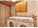 Efficient laundry room showcasing exposed ceiling and includes modern washer and dryer at 6126 S Pierson St, Littleton, CO 80127