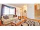 Cozy living room with a comfortable sofa, hardwood floors, and staircase access at 6126 S Pierson St, Littleton, CO 80127