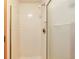 Shower with white tiles and glass door at 6126 S Pierson St, Littleton, CO 80127