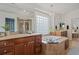Elegant bathroom with a soaking tub, double vanity, and a glass block window for natural light at 7408 Sodalite Way, Castle Rock, CO 80108