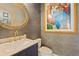 Charming powder room featuring ornate mirror and wallpaper, and marble countertop at 7408 Sodalite Way, Castle Rock, CO 80108