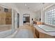 Spa-like bathroom featuring a glass shower, soaking tub, and dual vanities at 7408 Sodalite Way, Castle Rock, CO 80108