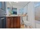 Cozy bathroom featuring a shower with a bathtub, vanity with storage at 7408 Sodalite Way, Castle Rock, CO 80108