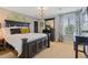 A primary bedroom featuring a large bed, dark wood furniture, and natural light at 7408 Sodalite Way, Castle Rock, CO 80108
