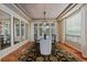 Formal dining room with stylish chandelier, large windows, and a decorative rug at 7408 Sodalite Way, Castle Rock, CO 80108