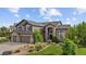 Beautiful two-story home with stone and siding, complemented by a well-manicured lawn and landscaping at 7408 Sodalite Way, Castle Rock, CO 80108