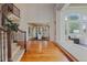 Open-concept foyer boasts wood floors, staircase with railing, and views into the formal dining room at 7408 Sodalite Way, Castle Rock, CO 80108