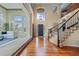 Grand foyer featuring soaring ceilings, hardwood floors, and a staircase with iron railings at 7408 Sodalite Way, Castle Rock, CO 80108