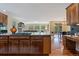 View of kitchen, living room, and dining room featuring hardwood floors and natural light at 7408 Sodalite Way, Castle Rock, CO 80108