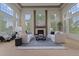 Bright and airy living room featuring a cozy fireplace, large windows, and comfortable seating at 7408 Sodalite Way, Castle Rock, CO 80108