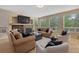 Bright living room featuring a fireplace, plush seating, carpet, and ample natural light at 7408 Sodalite Way, Castle Rock, CO 80108