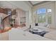Spacious living area with vaulted ceiling, large windows, and elegant staircase at 7408 Sodalite Way, Castle Rock, CO 80108