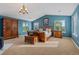 Spacious main bedroom featuring blue walls, a large wooden bed, and ample natural light from multiple windows at 7408 Sodalite Way, Castle Rock, CO 80108