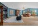 Inviting main bedroom with a cozy seating area, fireplace, and stylish blue walls at 7408 Sodalite Way, Castle Rock, CO 80108