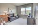 Comfortable bedroom features a black leather sofa, desk and chair with a bright window view at 2790 Center Park Way, Berthoud, CO 80513