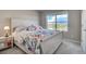 Comfortable bedroom features a charming bed with floral bedding, a nightstand, and a bright window view at 2790 Center Park Way, Berthoud, CO 80513