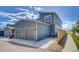View of the home's exterior featuring a two-car garage, blue siding, and a well-kept lawn at 2790 Center Park Way, Berthoud, CO 80513