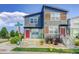 Modern townhome with gray siding, wood accents, and a welcoming red front door at 2790 Center Park Way, Berthoud, CO 80513