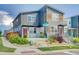 Inviting modern townhome with red doors, gray siding, and well-manicured landscaping at 2790 Center Park Way, Berthoud, CO 80513