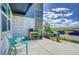 Inviting front porch with comfortable blue seating, a charming plant rack, and views of the neighborhood at 2790 Center Park Way, Berthoud, CO 80513