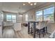 Open-concept layout connecting the kitchen and dining area, featuring stylish seating and abundant natural light at 2790 Center Park Way, Berthoud, CO 80513
