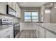 Modern kitchen with stainless steel appliances, granite countertops, and stylish backsplash, offering great views at 2790 Center Park Way, Berthoud, CO 80513