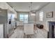 Open kitchen features stainless steel appliances, granite countertops, and ample storage, seamlessly flowing into the dining area at 2790 Center Park Way, Berthoud, CO 80513