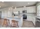 Well-equipped kitchen with stainless appliances, white cabinets, and a granite-topped center island at 2790 Center Park Way, Berthoud, CO 80513