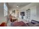 Relaxing living room with a wall-mounted TV, ladder bookshelf, and comfortable leather seating with views to the entryway at 2790 Center Park Way, Berthoud, CO 80513