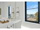 Modern bathroom with a view and white vanity at 4244 E 8Th Pl, Denver, CO 80220