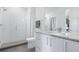 Bright bathroom featuring modern white cabinetry, granite counters, and glass shower at 4244 E 8Th Pl, Denver, CO 80220