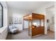 Cozy bedroom featuring a unique wooden loft bed, soft chair, and natural light at 4244 E 8Th Pl, Denver, CO 80220